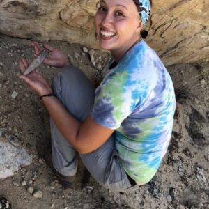 Undergraduate student Amber Czubernat holding an intact blade in Moffat County in 2018