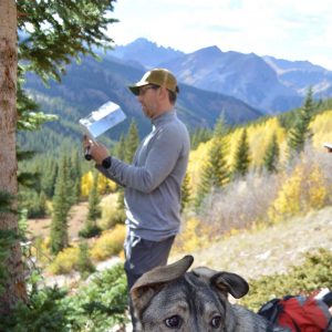 Jason Sibold researching beetle kill and fires with dog