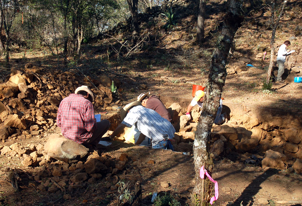 Image of Mesoamerican field site with five people excavating