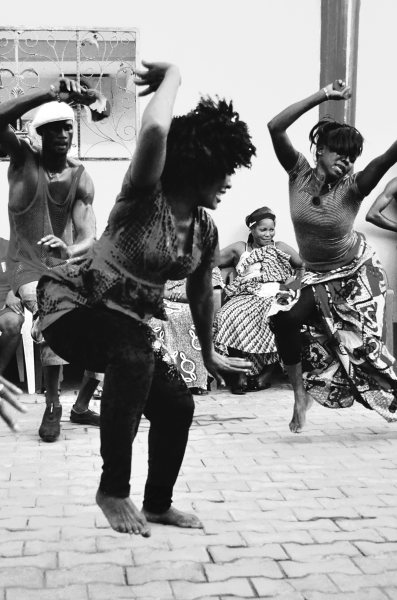 Woman dancing with arms in air, Conakry, Guinea