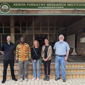 Researchers standing outside forestry research institute in Kenya