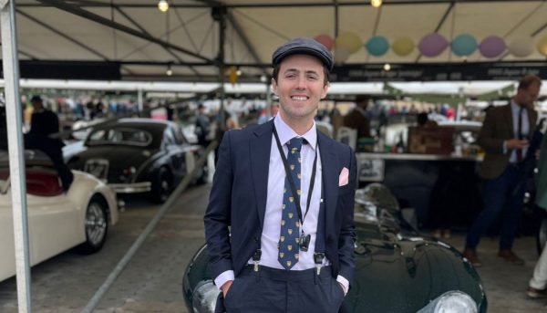 Justin Smith poses in front of an English car at a festival in West Sussex, England