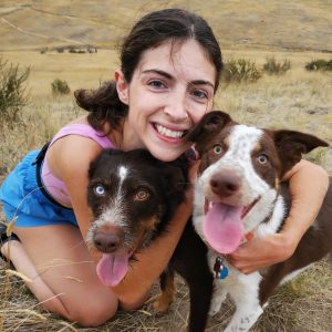 Woman hugging two doge