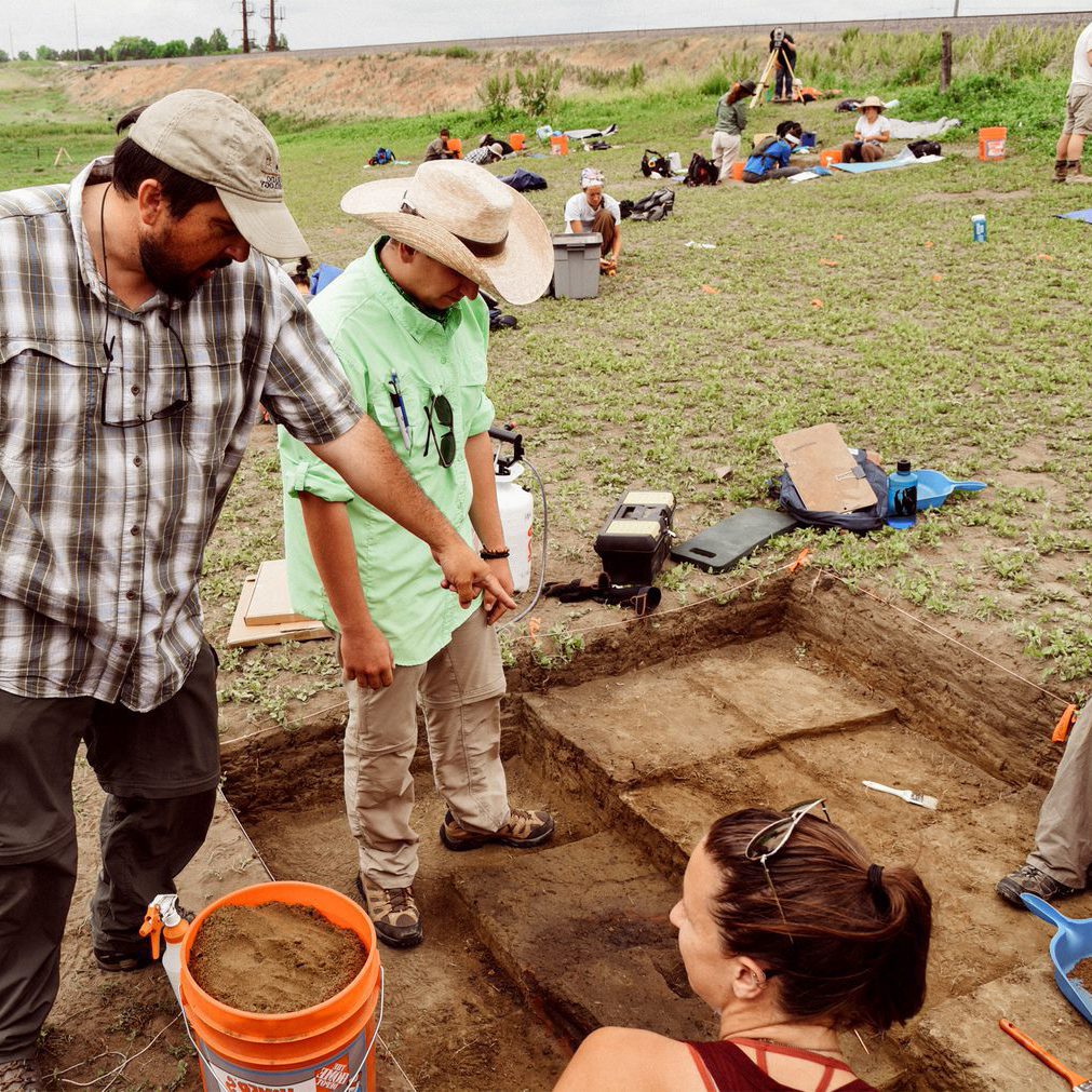 Anthropology students and professors digging at a site