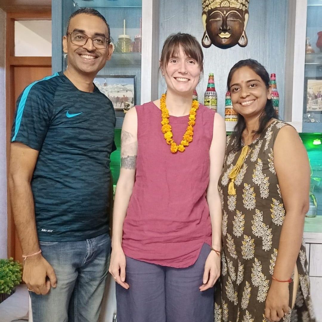 CSU Anthropology student with a couple in their home in Dehli, India.