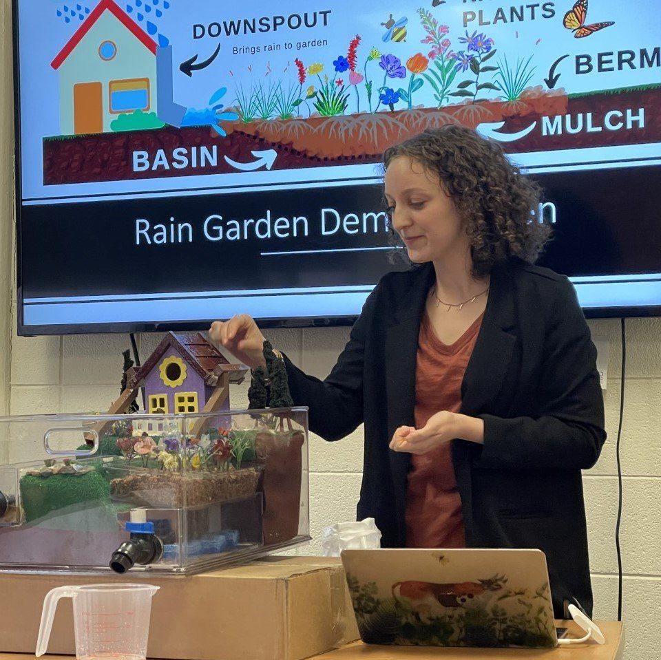 Master's student Riley Lynch with a demonstration at her thesis defense, March 2023. Lynch is advised by Dr. Heidi Hausermann and affiliate faculty Jessica Thrasher of the Colorado Stormwater Center (Image via Heidi Hausermann)