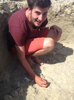 Anthropology student cutting into the dirt