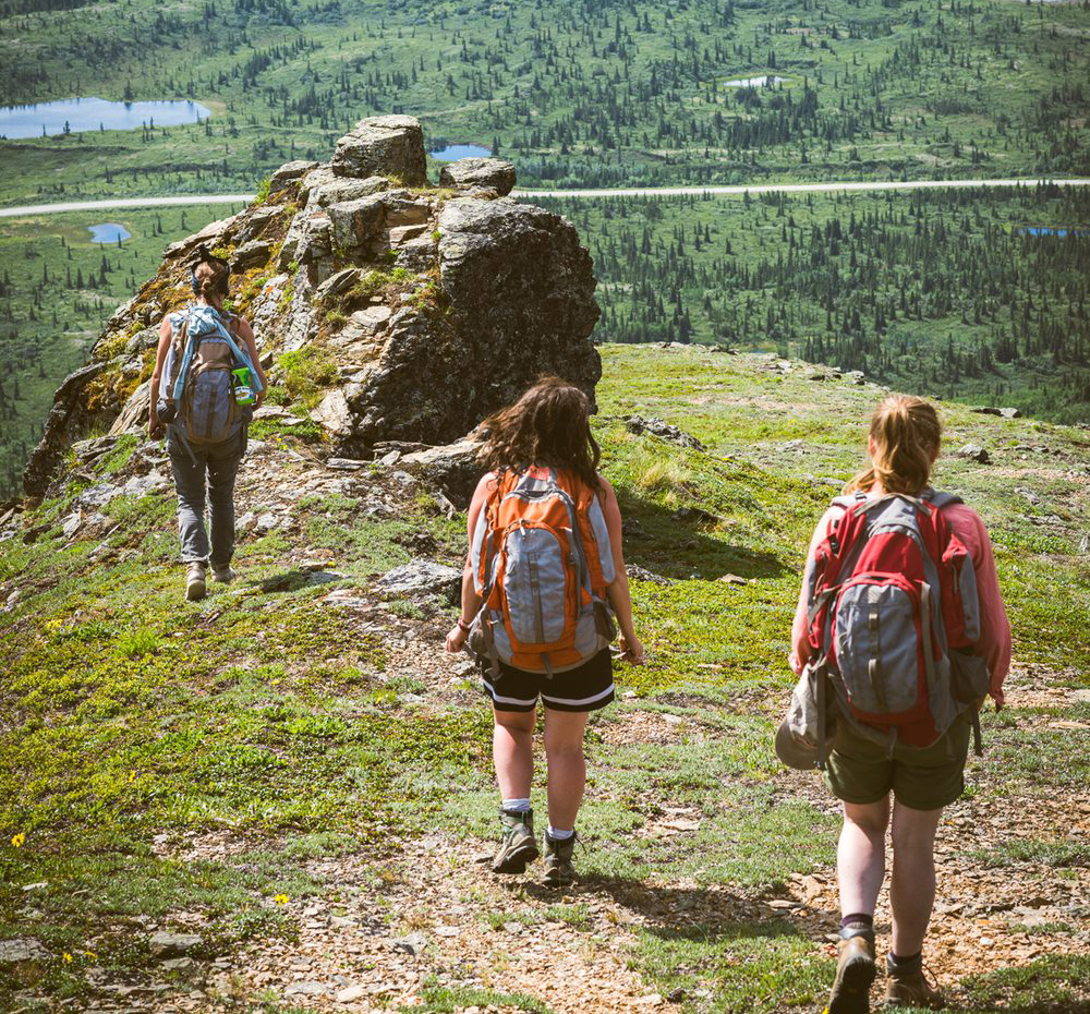 Students walking toward edge of lookout point on cliff