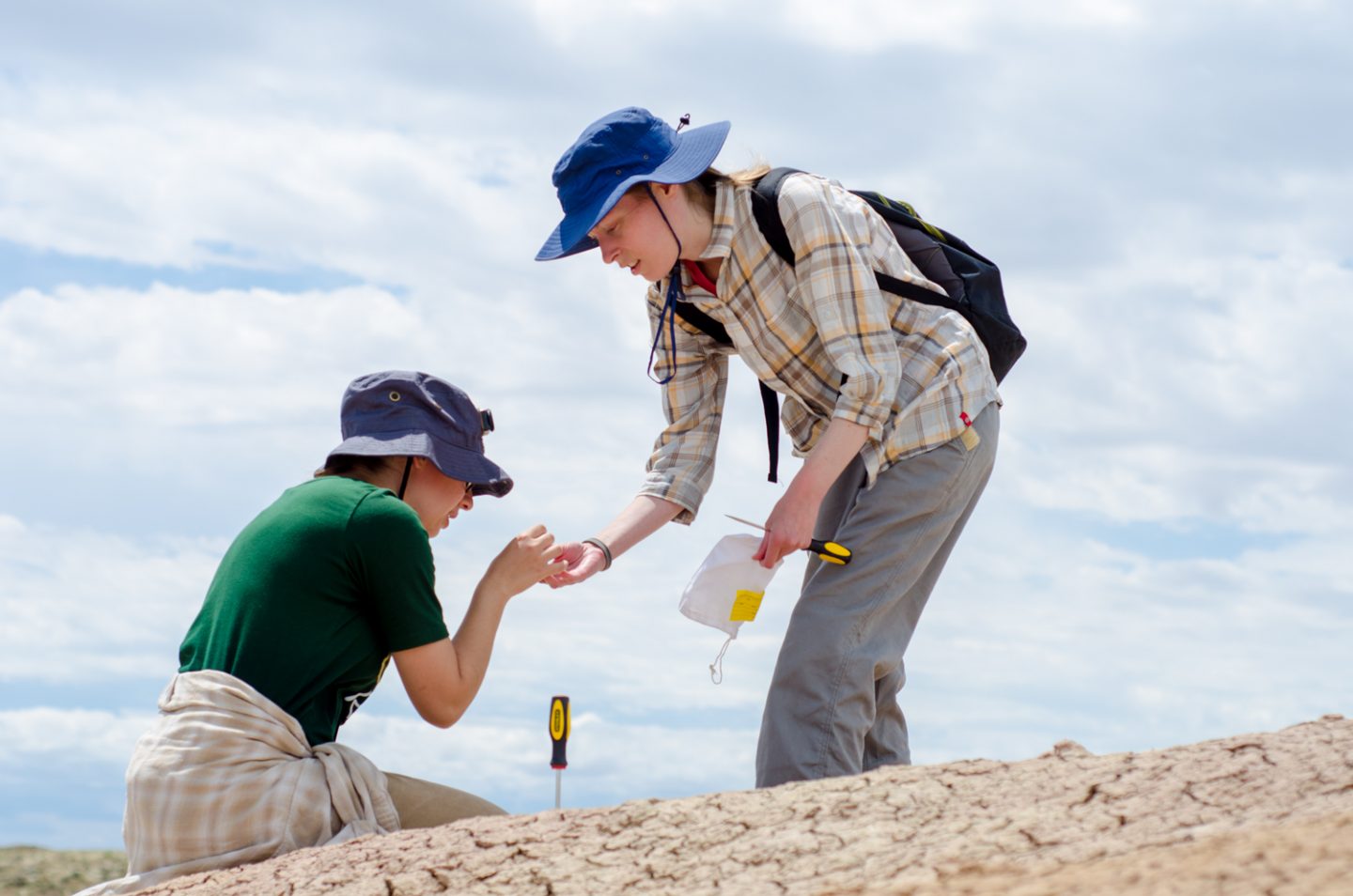 Two students checking out what they found in the field