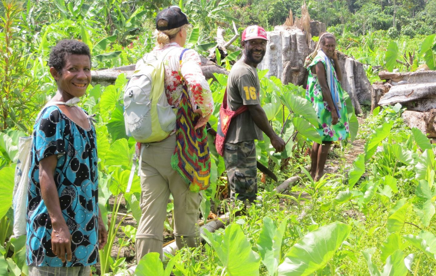 Geography student walking on trail with local people