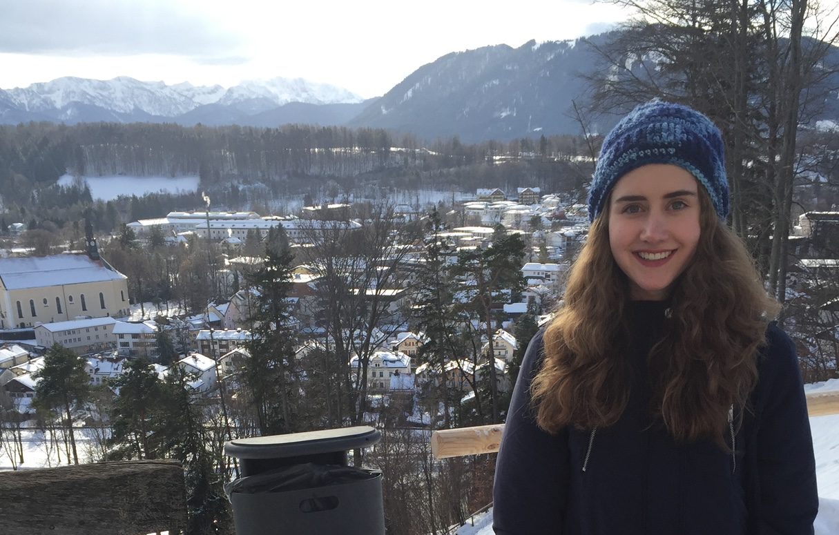 Student standing in front of city view with snow