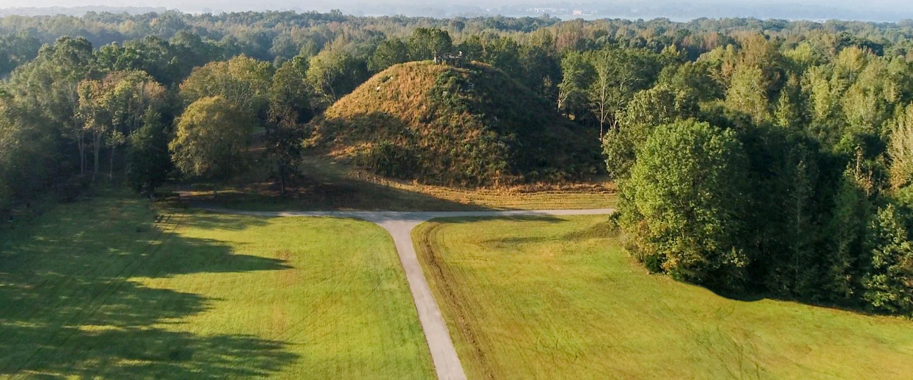 Landscape photo of Pinson Mounds in tennessee showing road in park and mound