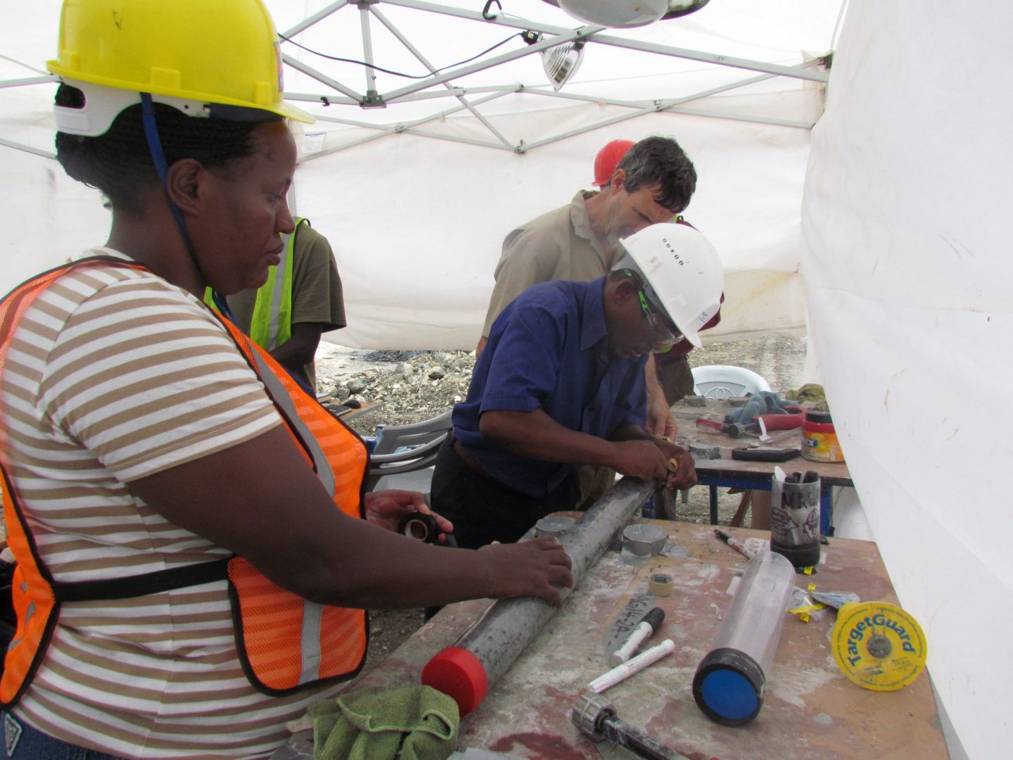 Researchers label a freshly sealed sediment core sample from Lake Magadi in Kenya