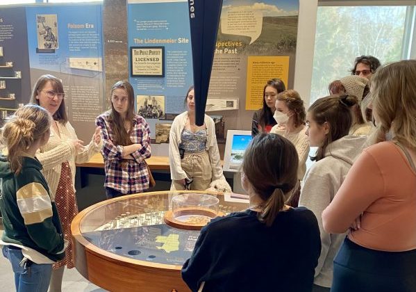 Students listen to staff member at science museum