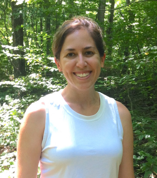 Professor headshot photo, in front of forest