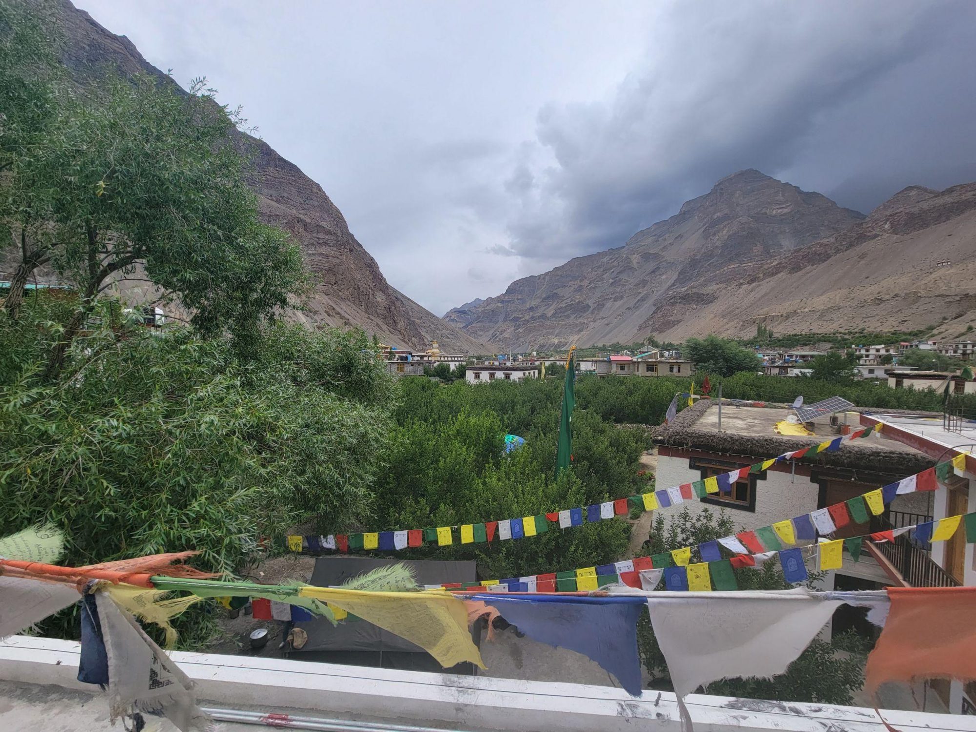 Prayer flags in Himachal Pradesh, India, looking along a valley with mountains