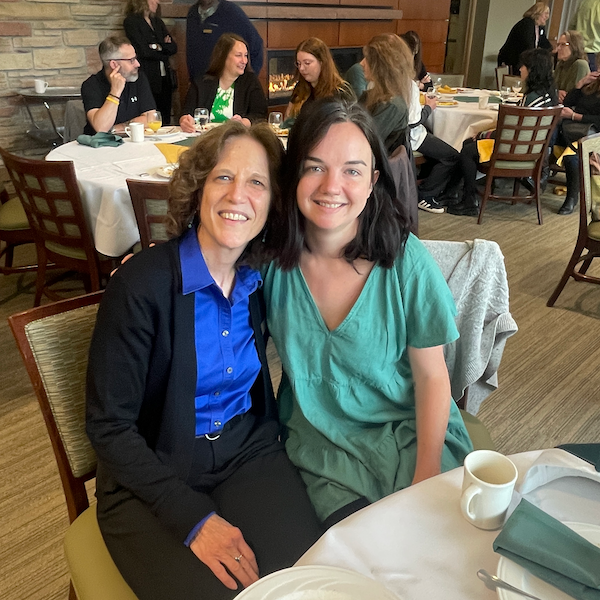 Professor and graduate student at graduation breakfast